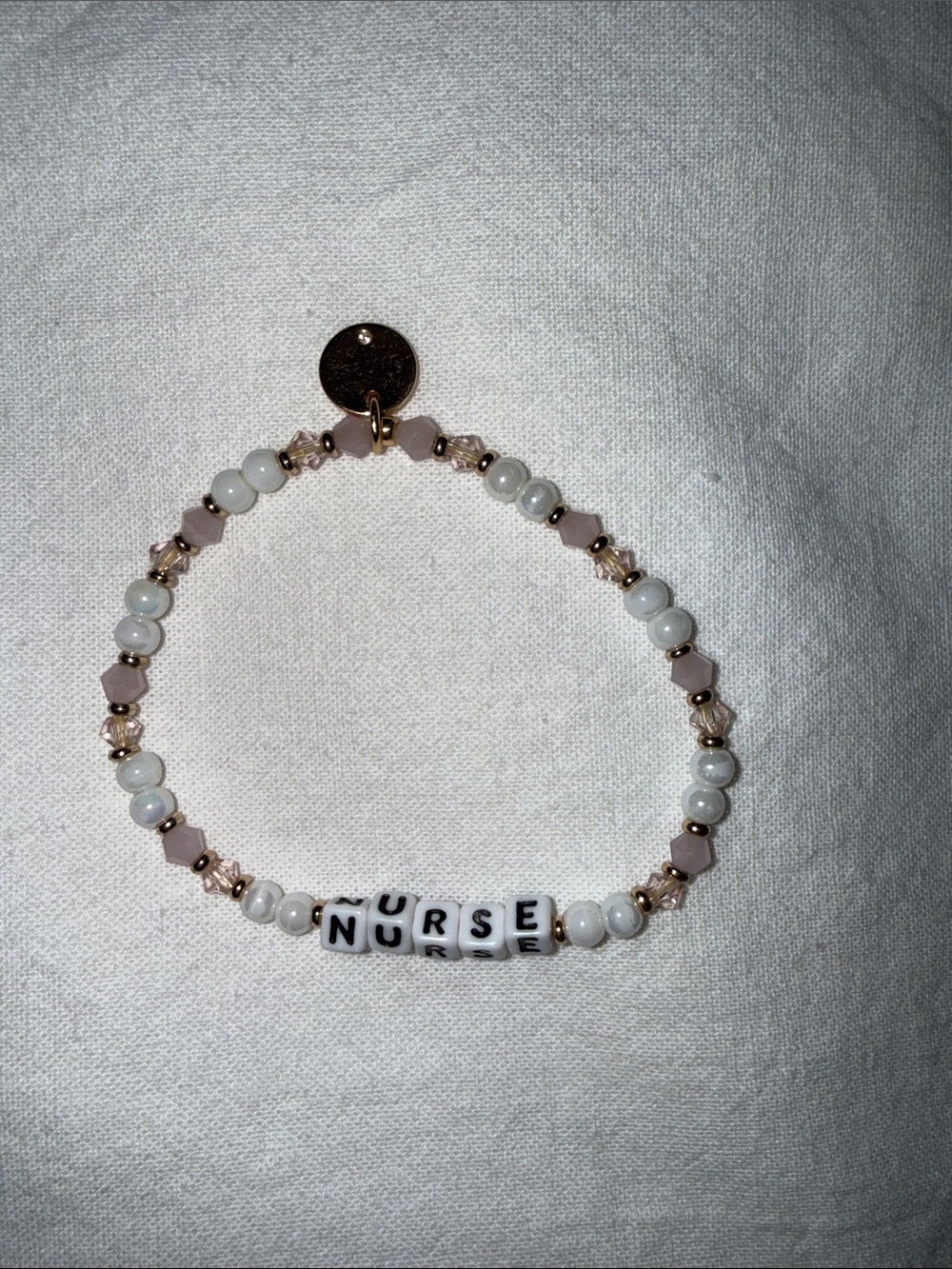 Little words project 
“NURSE" Beaded Stretch Bracelet in White and Light Pink